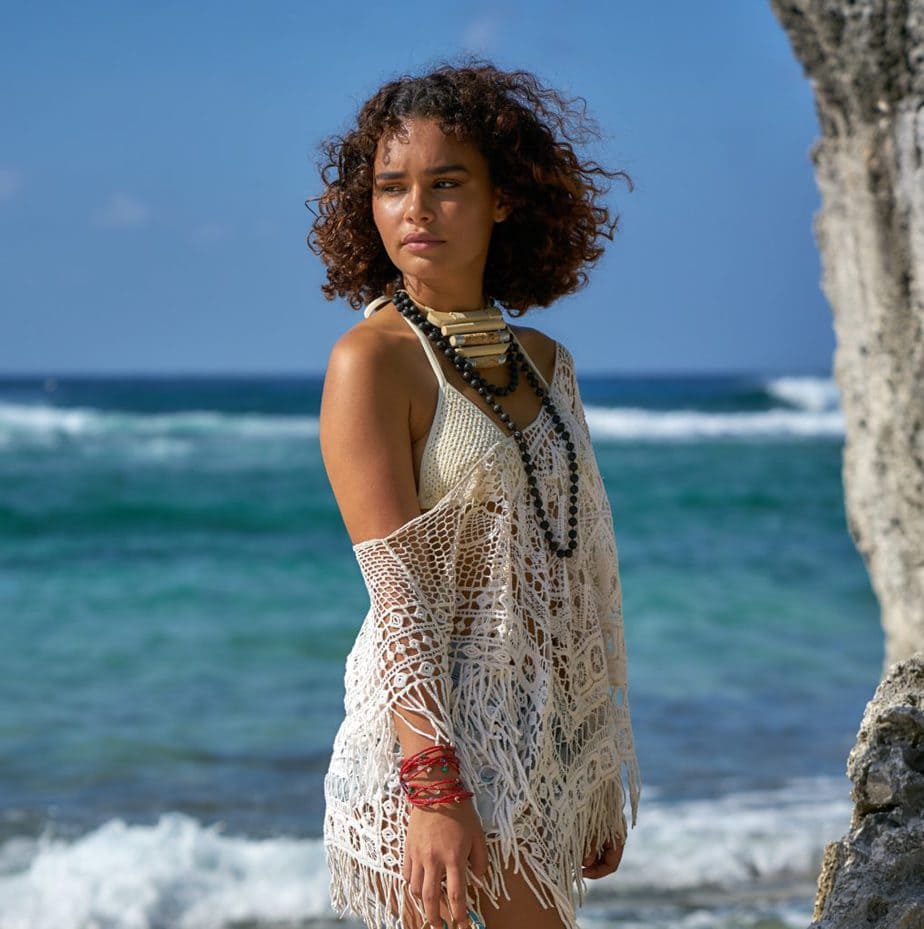 woman in white knit tank top and blue denim shorts standing on rock formation near sea scopio e1afb4b6 6dff 4241 b5ba bc068c2b85b2 Copy